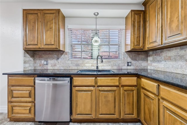 kitchen featuring dishwasher, decorative backsplash, sink, and hanging light fixtures