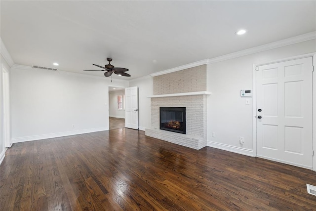 unfurnished living room with ceiling fan, dark hardwood / wood-style flooring, ornamental molding, and a fireplace