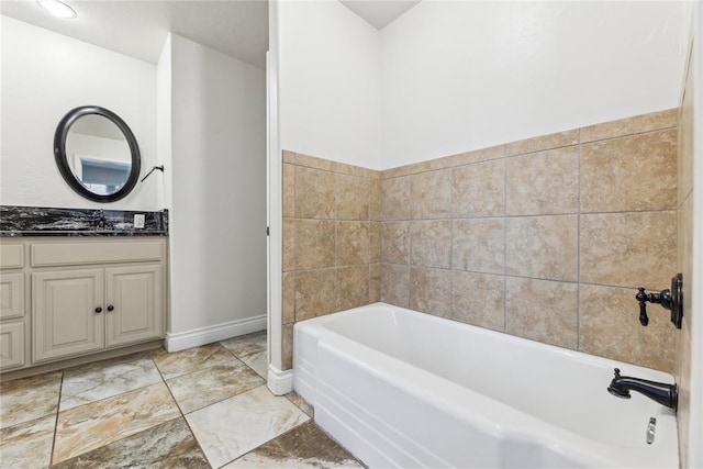 bathroom featuring vanity and a tub