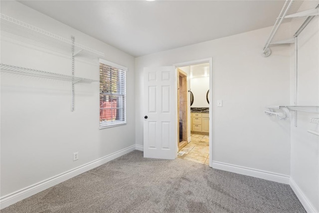 walk in closet with carpet floors