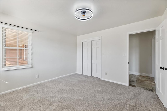 unfurnished bedroom featuring a closet and carpet