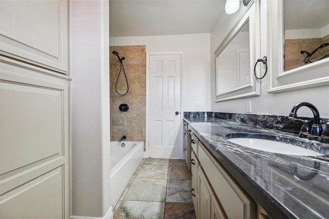 bathroom featuring vanity and tiled shower / bath combo