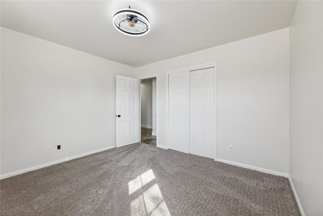 unfurnished bedroom featuring carpet floors and a closet