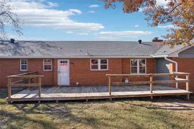 back of property featuring a yard and a deck