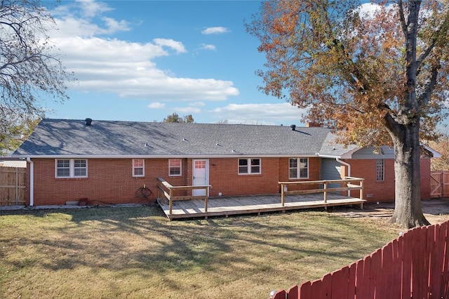 back of property with a yard and a deck