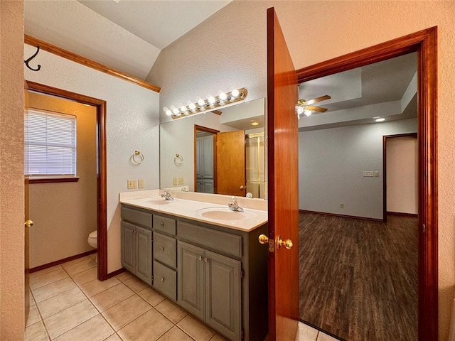 bathroom featuring tile patterned floors, vanity, ceiling fan, toilet, and lofted ceiling