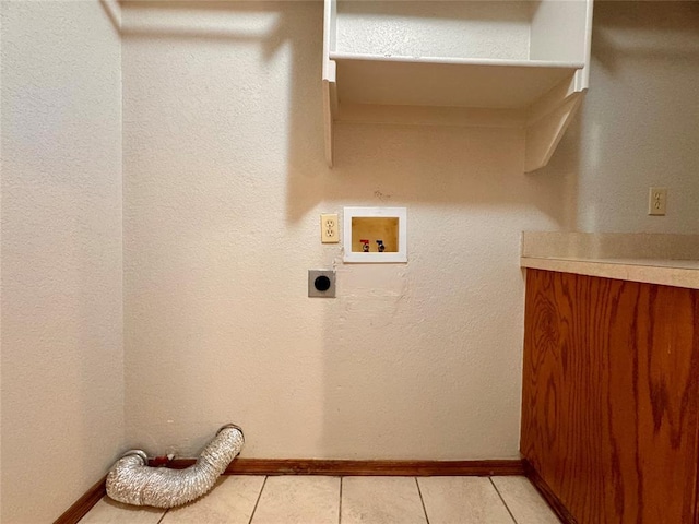 clothes washing area with hookup for a washing machine, light tile patterned flooring, and hookup for an electric dryer