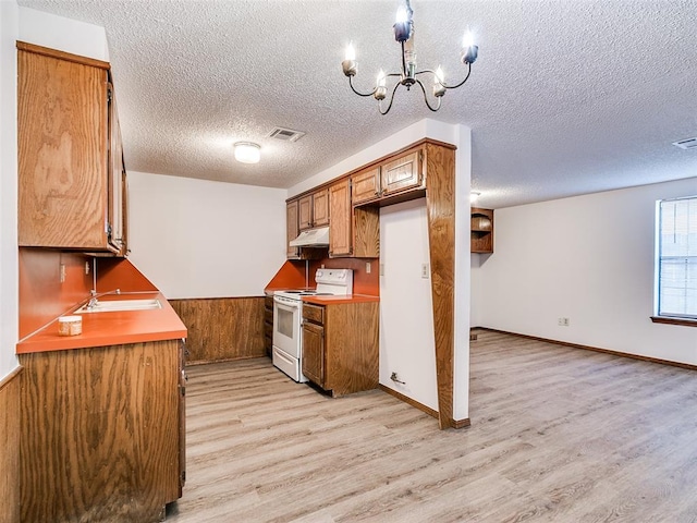 kitchen featuring light hardwood / wood-style floors, white electric range, and a textured ceiling