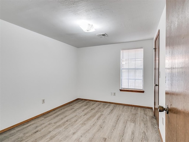 unfurnished room with light hardwood / wood-style flooring