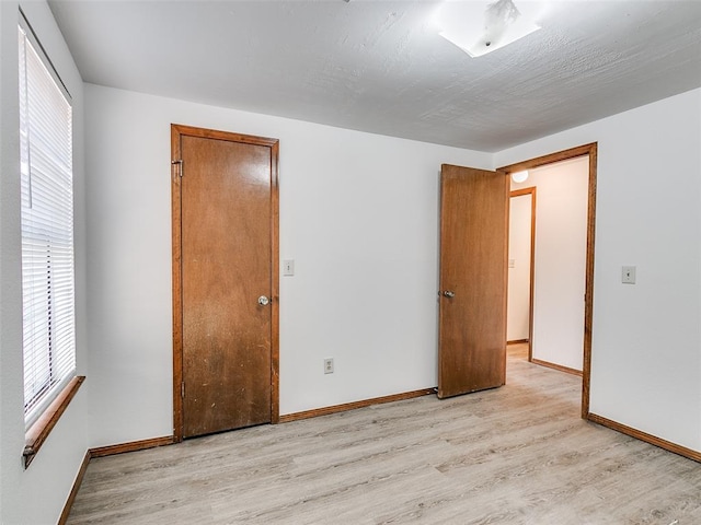 empty room featuring a healthy amount of sunlight and light wood-type flooring