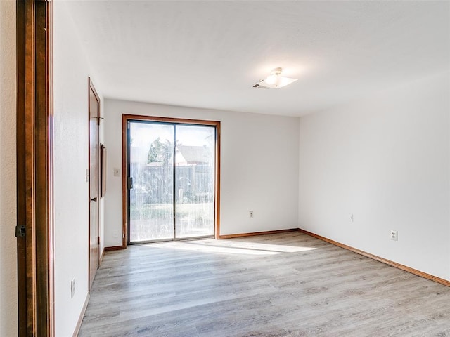 unfurnished room with light hardwood / wood-style floors