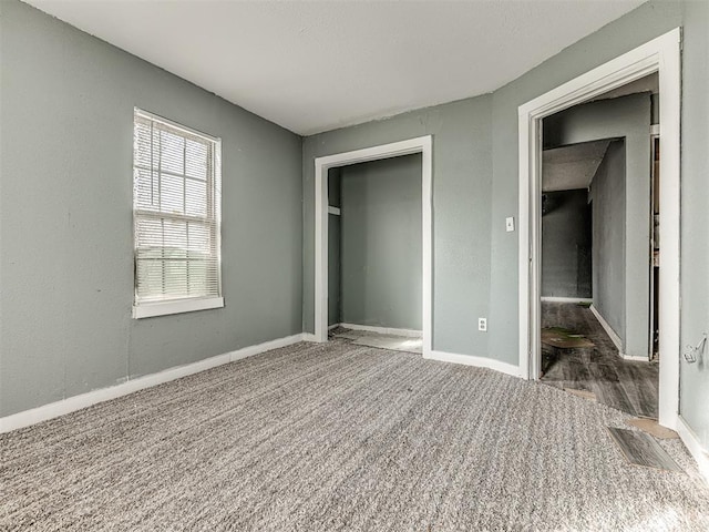 unfurnished bedroom featuring dark carpet