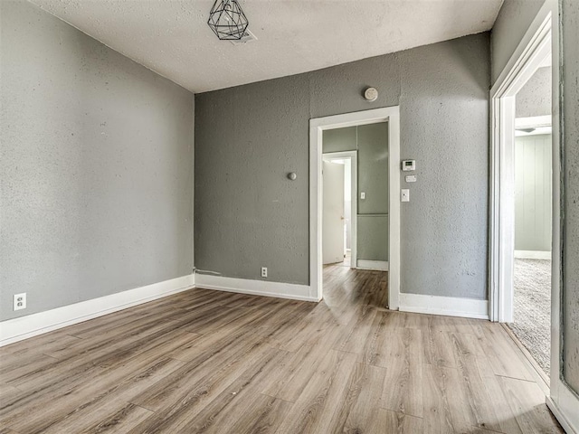 unfurnished room with light hardwood / wood-style floors