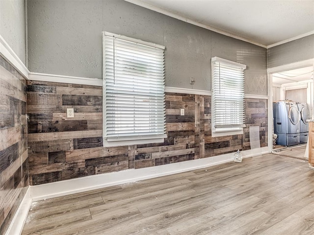 kitchen featuring hardwood / wood-style flooring, wooden walls, and ornamental molding