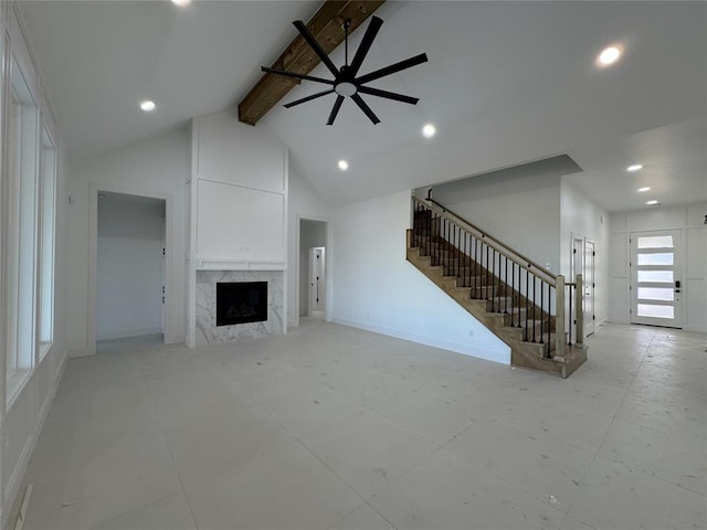 unfurnished living room featuring high vaulted ceiling, a fireplace, and beam ceiling