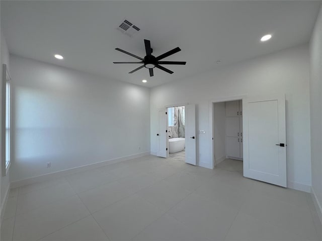 unfurnished bedroom featuring connected bathroom and ceiling fan