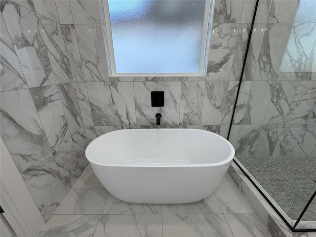 bathroom featuring a tub to relax in