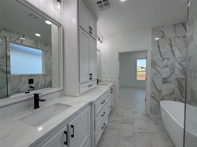 bathroom with vanity and a tub