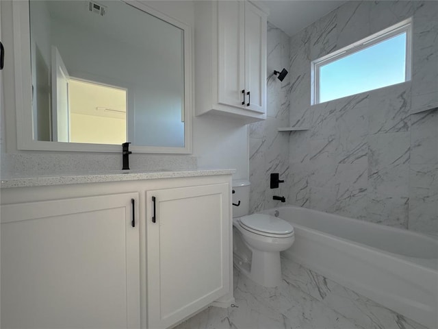 full bathroom with tiled shower / bath combo, vanity, and toilet