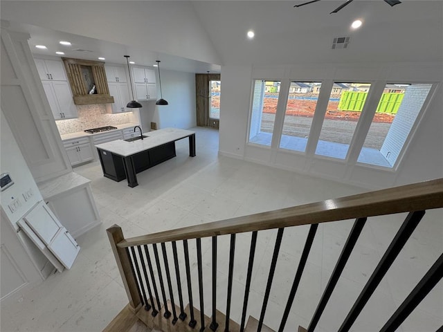 stairs with high vaulted ceiling and sink