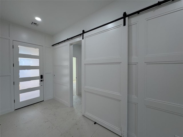 foyer entrance with a barn door