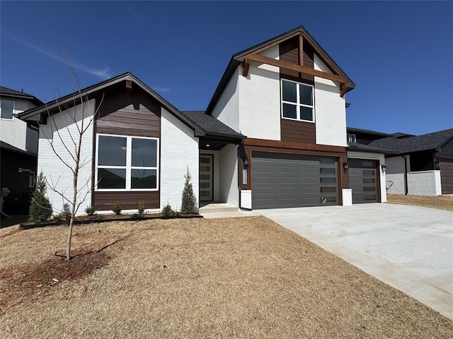 view of front of home with driveway, brick siding, and an attached garage