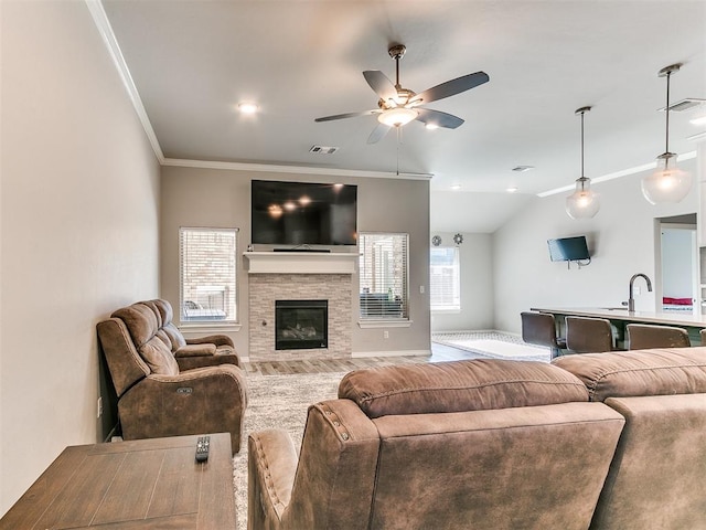 living room featuring ceiling fan, crown molding, and vaulted ceiling