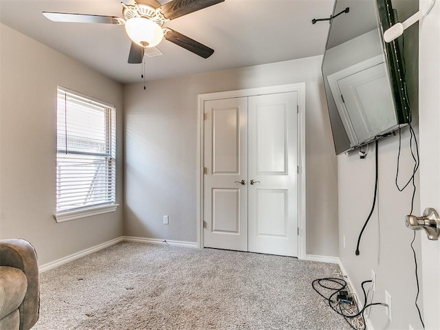 interior space with ceiling fan and a closet