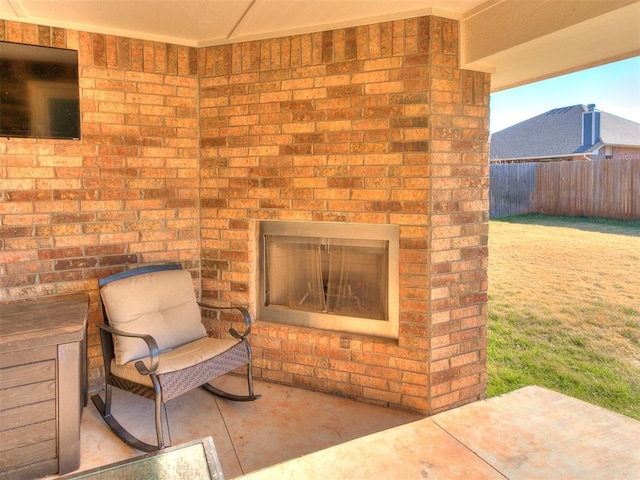 view of patio featuring an outdoor brick fireplace