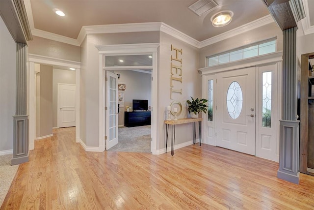 entrance foyer featuring crown molding and light hardwood / wood-style flooring