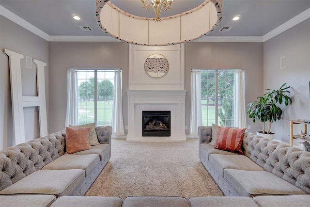 living room featuring carpet, a chandelier, a brick fireplace, and crown molding