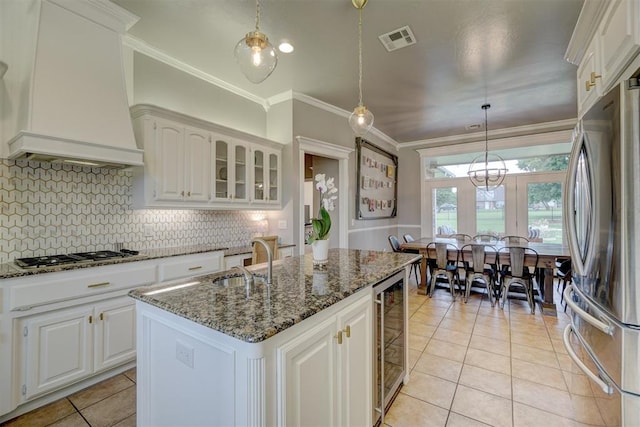 kitchen featuring white cabinetry, sink, custom exhaust hood, and appliances with stainless steel finishes