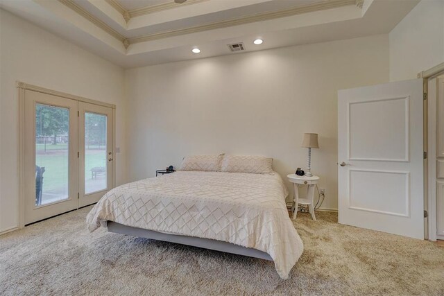 bedroom featuring access to exterior, carpet floors, a tray ceiling, and crown molding