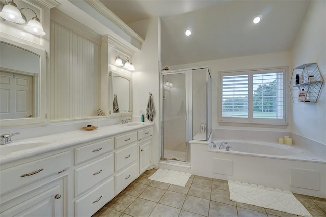 bathroom with tile patterned floors, vanity, separate shower and tub, and lofted ceiling