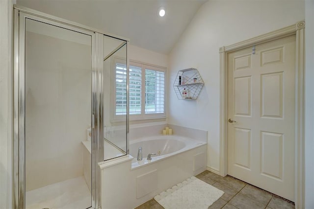 bathroom with tile patterned flooring, separate shower and tub, and lofted ceiling