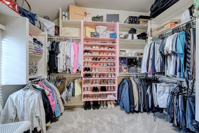 walk in closet featuring carpet flooring and vaulted ceiling