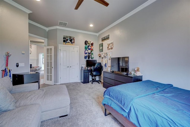 carpeted bedroom featuring a closet, ceiling fan, and crown molding