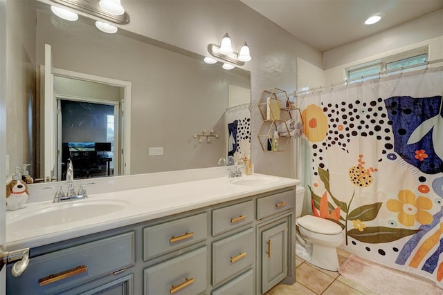 bathroom with tile patterned floors, curtained shower, vanity, and toilet