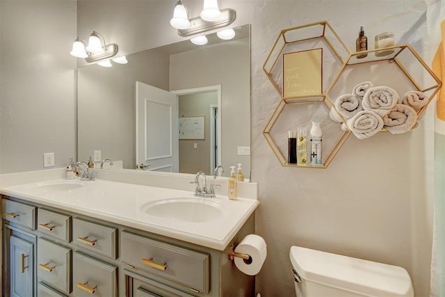 bathroom featuring vanity and toilet