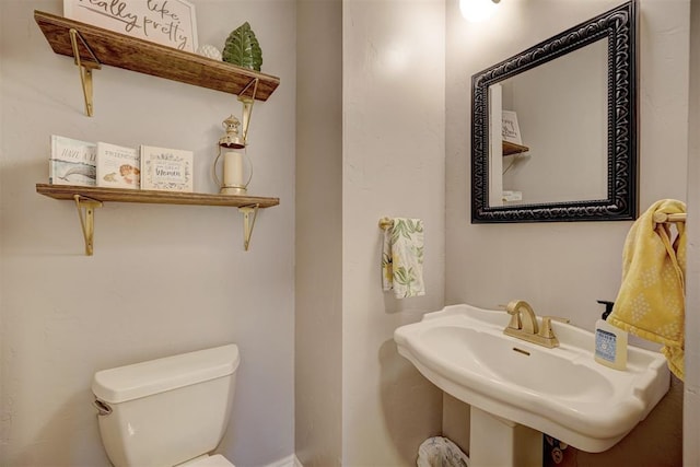 bathroom featuring toilet and sink