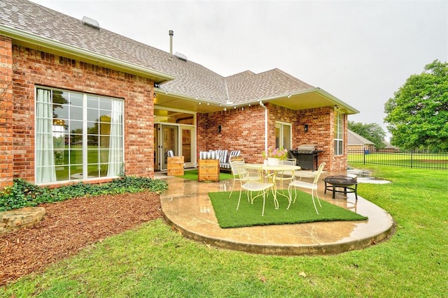 rear view of property featuring a yard and a patio area