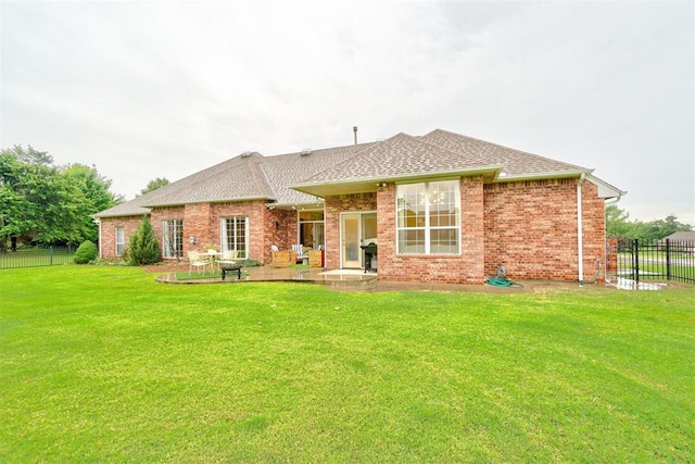 rear view of house with a lawn