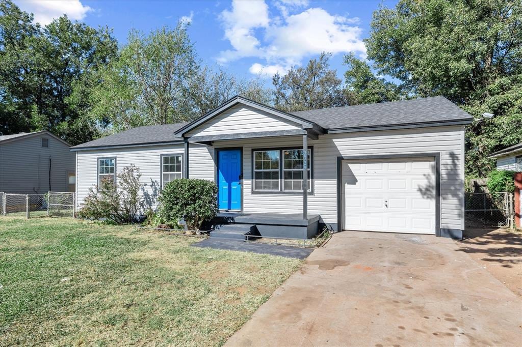 single story home with a garage and a front yard