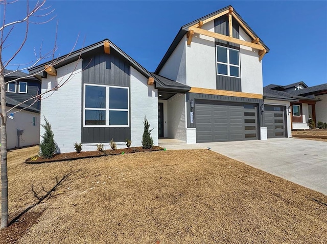 view of front facade featuring a garage, brick siding, board and batten siding, and concrete driveway