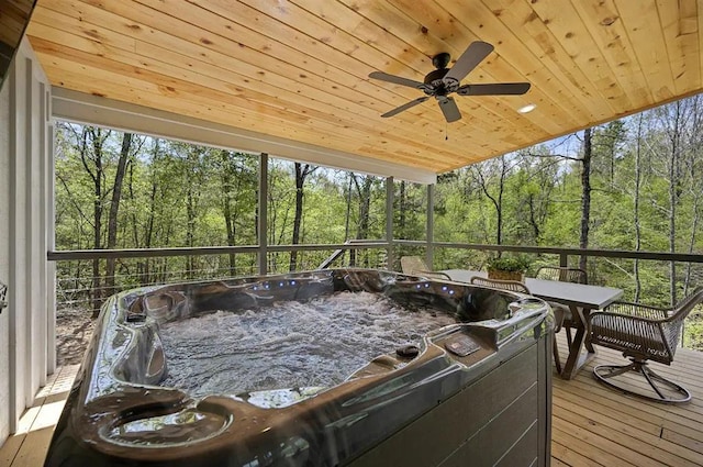 sunroom / solarium featuring a hot tub, plenty of natural light, and wood ceiling