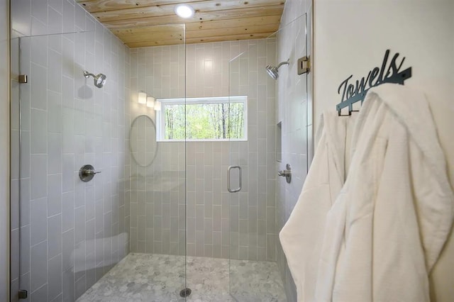 bathroom with tile patterned flooring, walk in shower, and wood ceiling