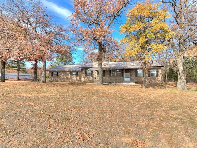 ranch-style home with a front lawn