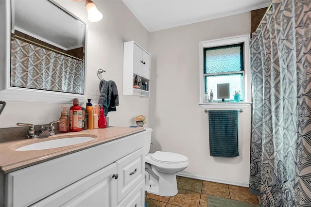 bathroom with tile patterned flooring, vanity, and toilet