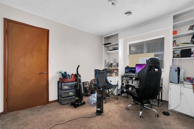 carpeted home office featuring a textured ceiling