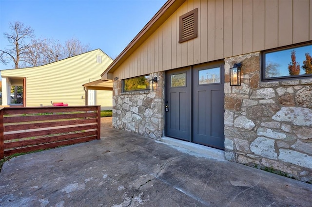 property entrance with stone siding